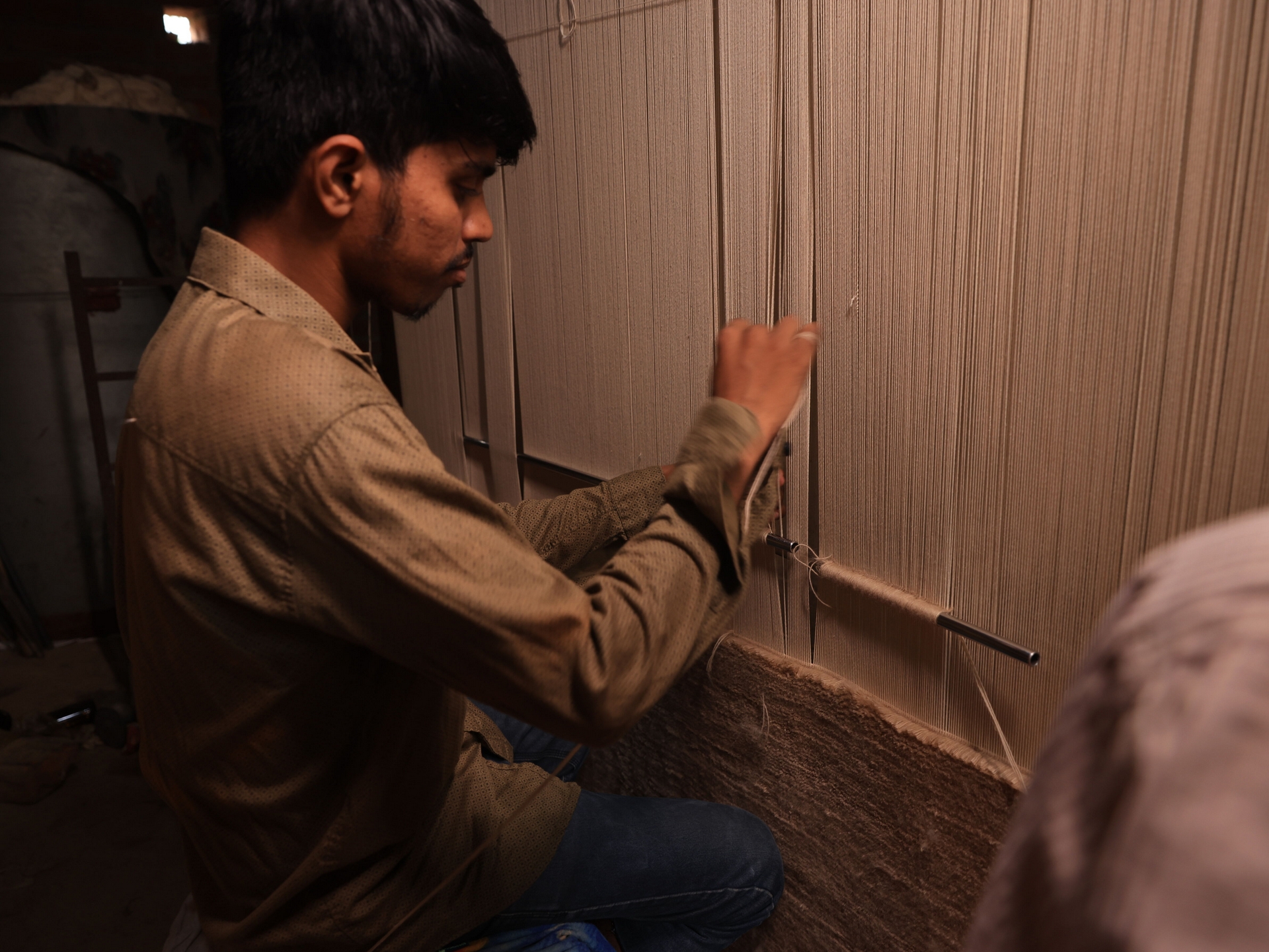 Handknotted rug being woven on a loom
