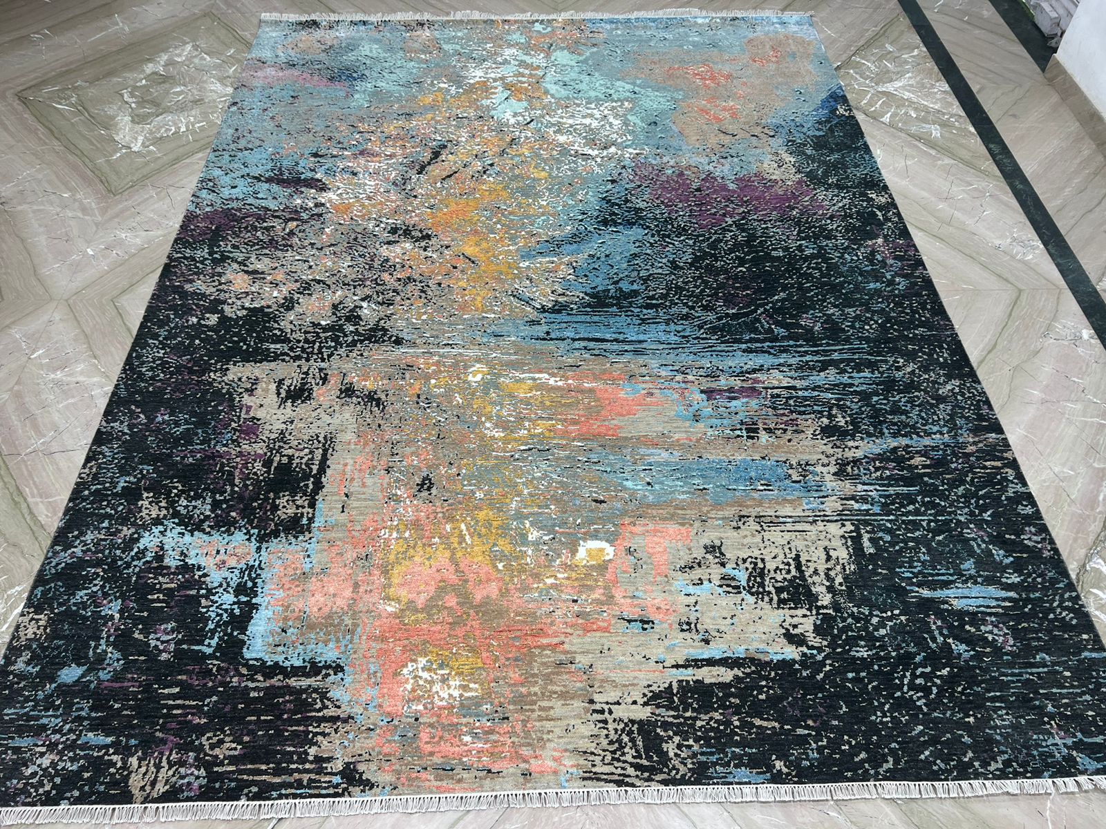 handknotted rug with abstract multicolor design on a dark base