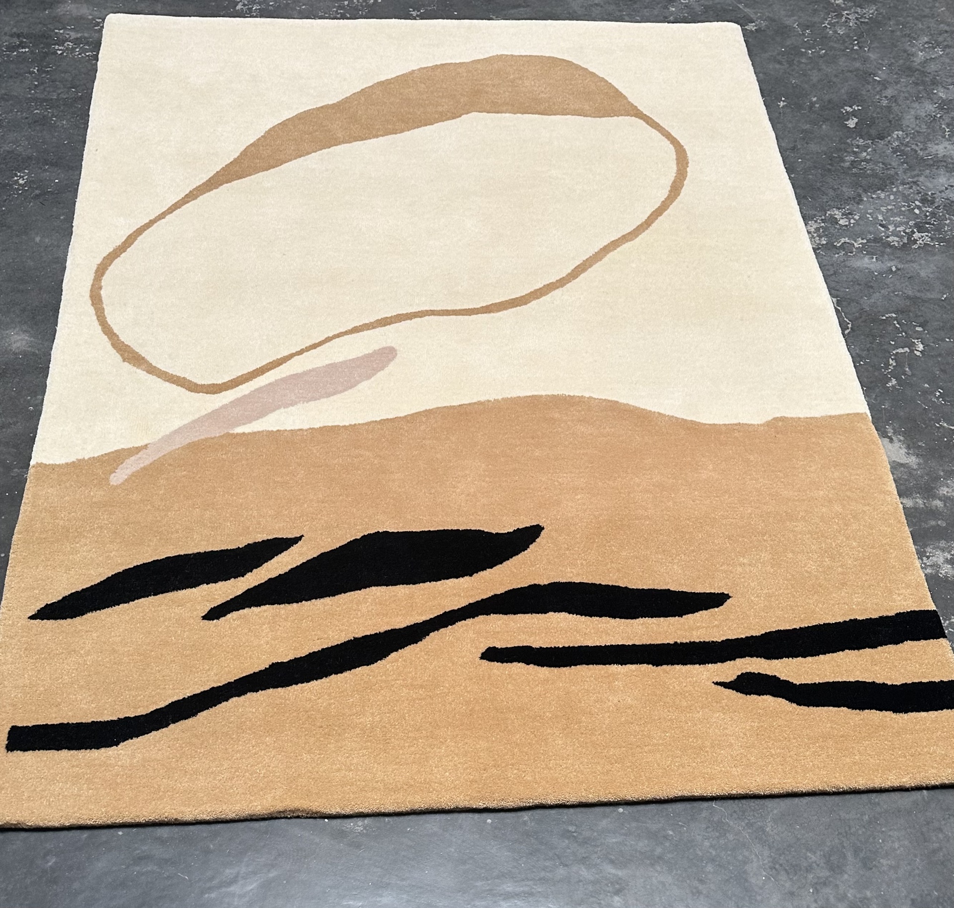 Modern abstract wool rug with desert inspired design in ivory terracotta and black, handtufted