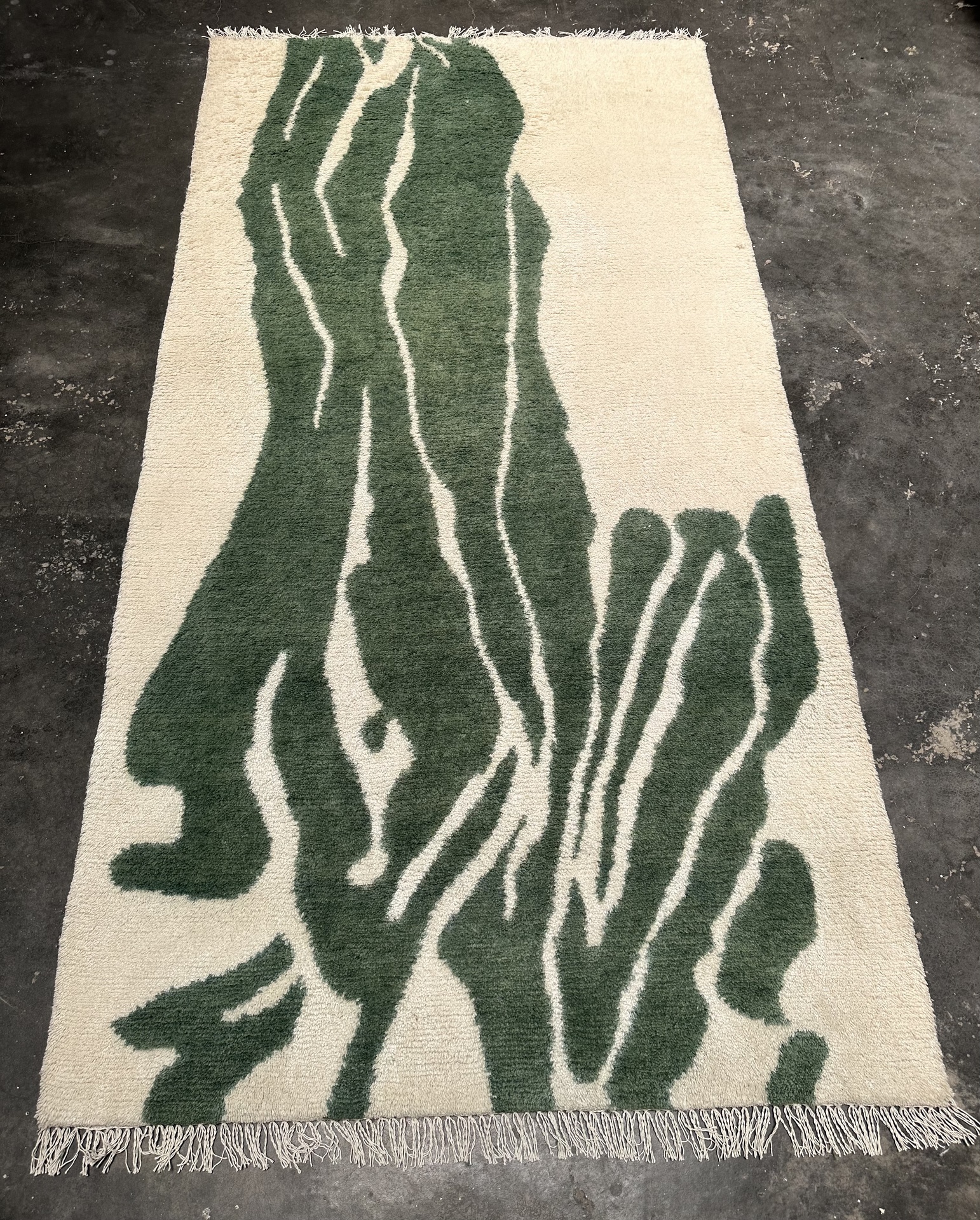 Green abstract handknotted wool rug with organic pattern